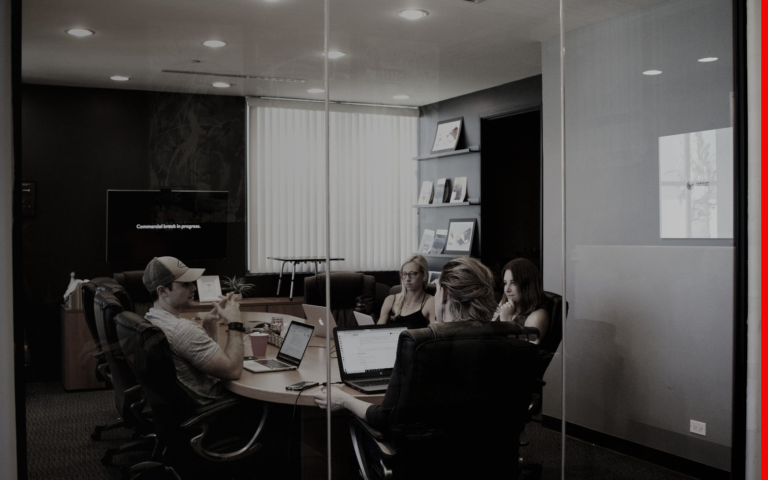 Creator team reviewing campaign details around a table